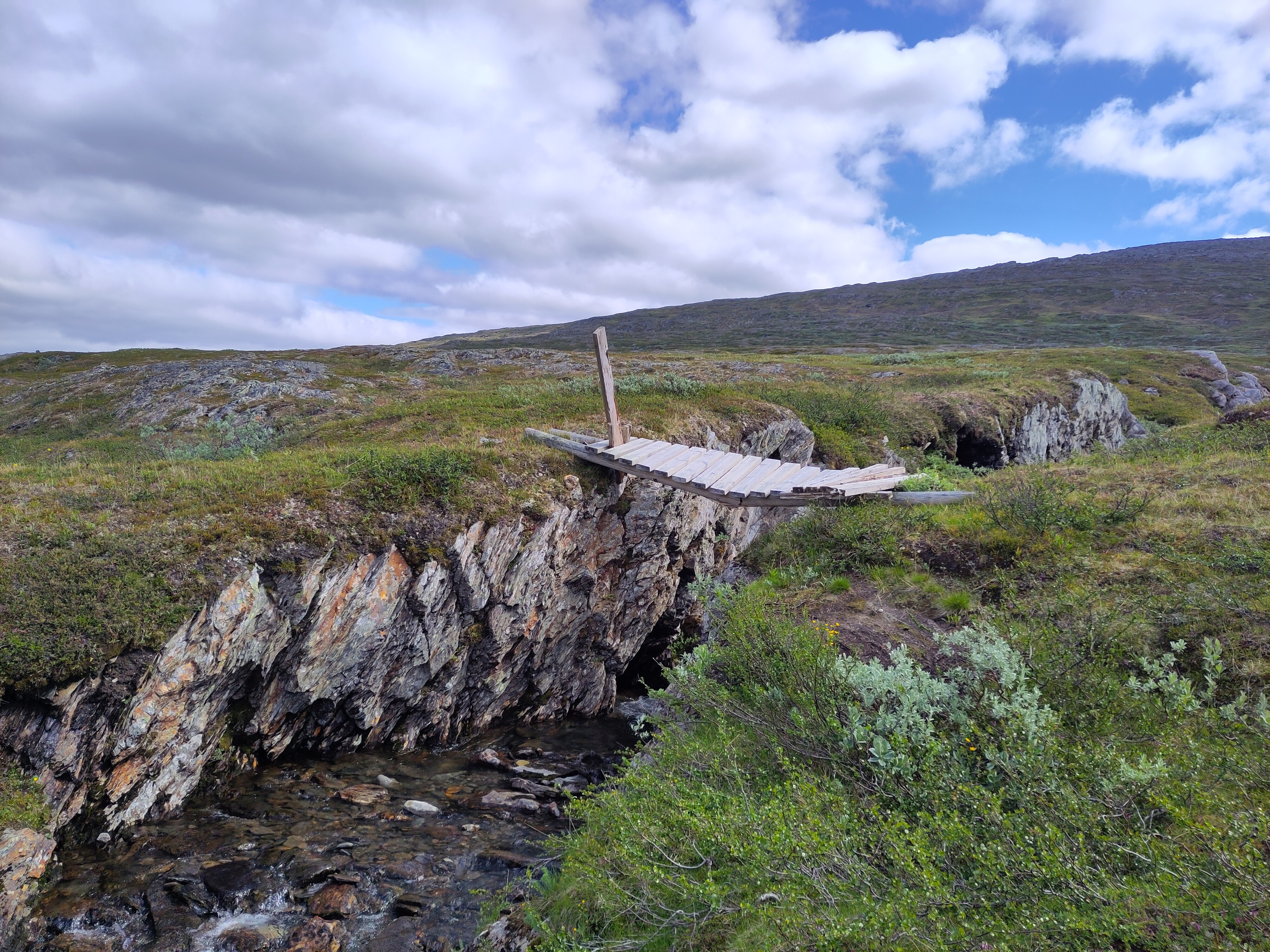 A broken bridge over a 5 m deep chasm with a stream on the bottom. Luckily the land flattened out a little bir downstream and the stream itself was easy to just walk through.