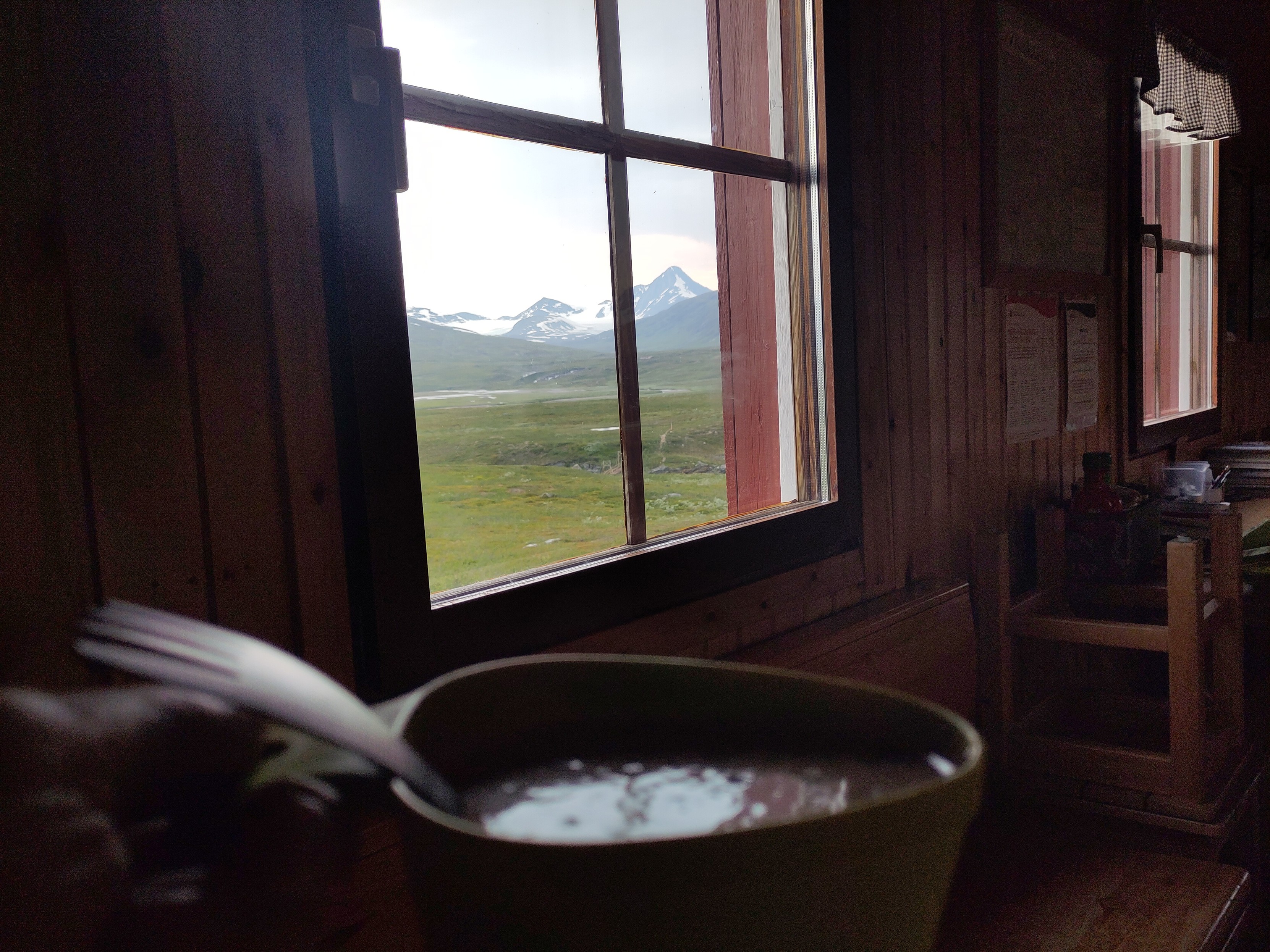 A similar view, but from further in the room, this time contrasted with a mug of hot cocoa with a spork in it.