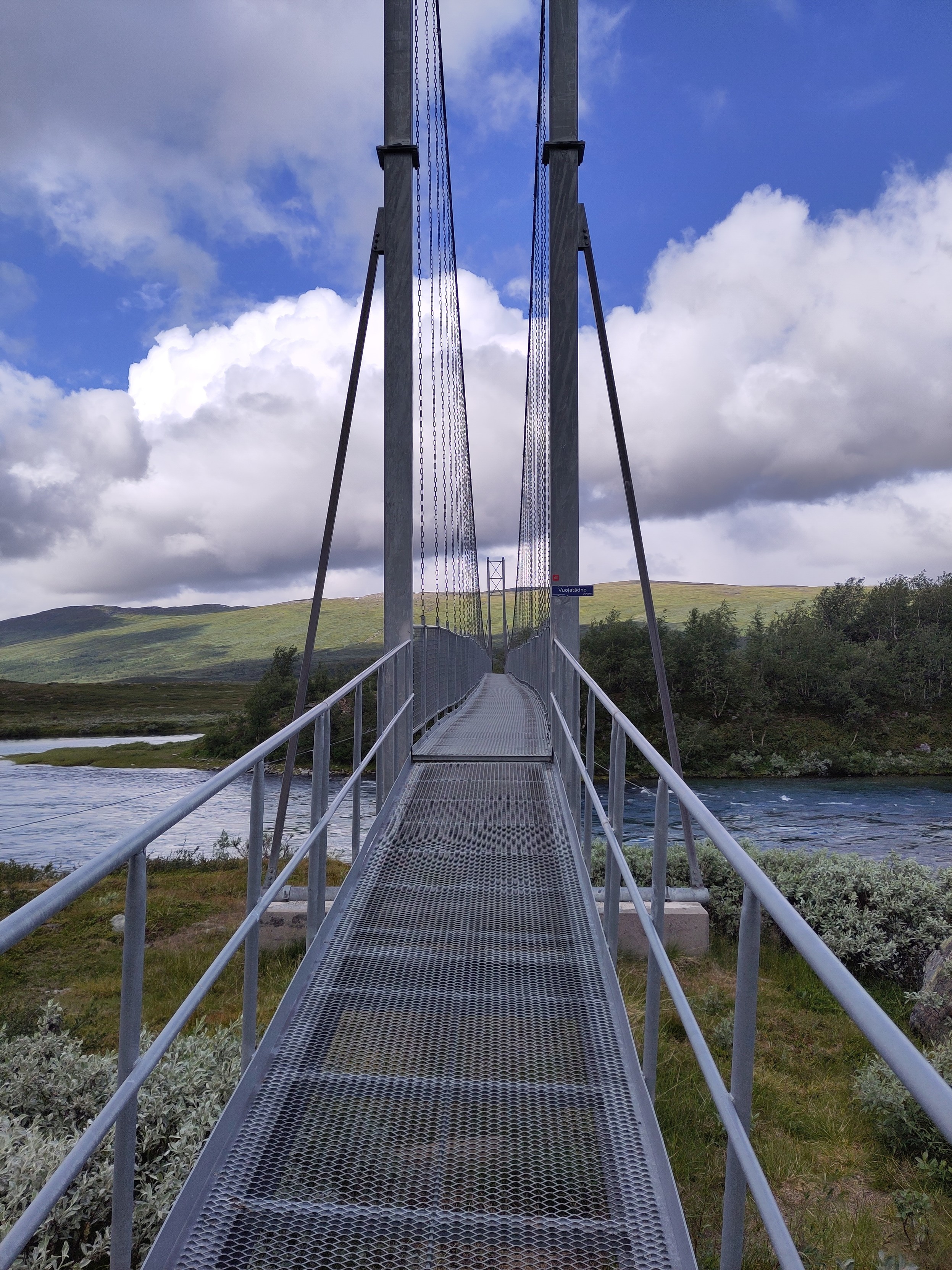 A long and tall suspension bridge over a river.