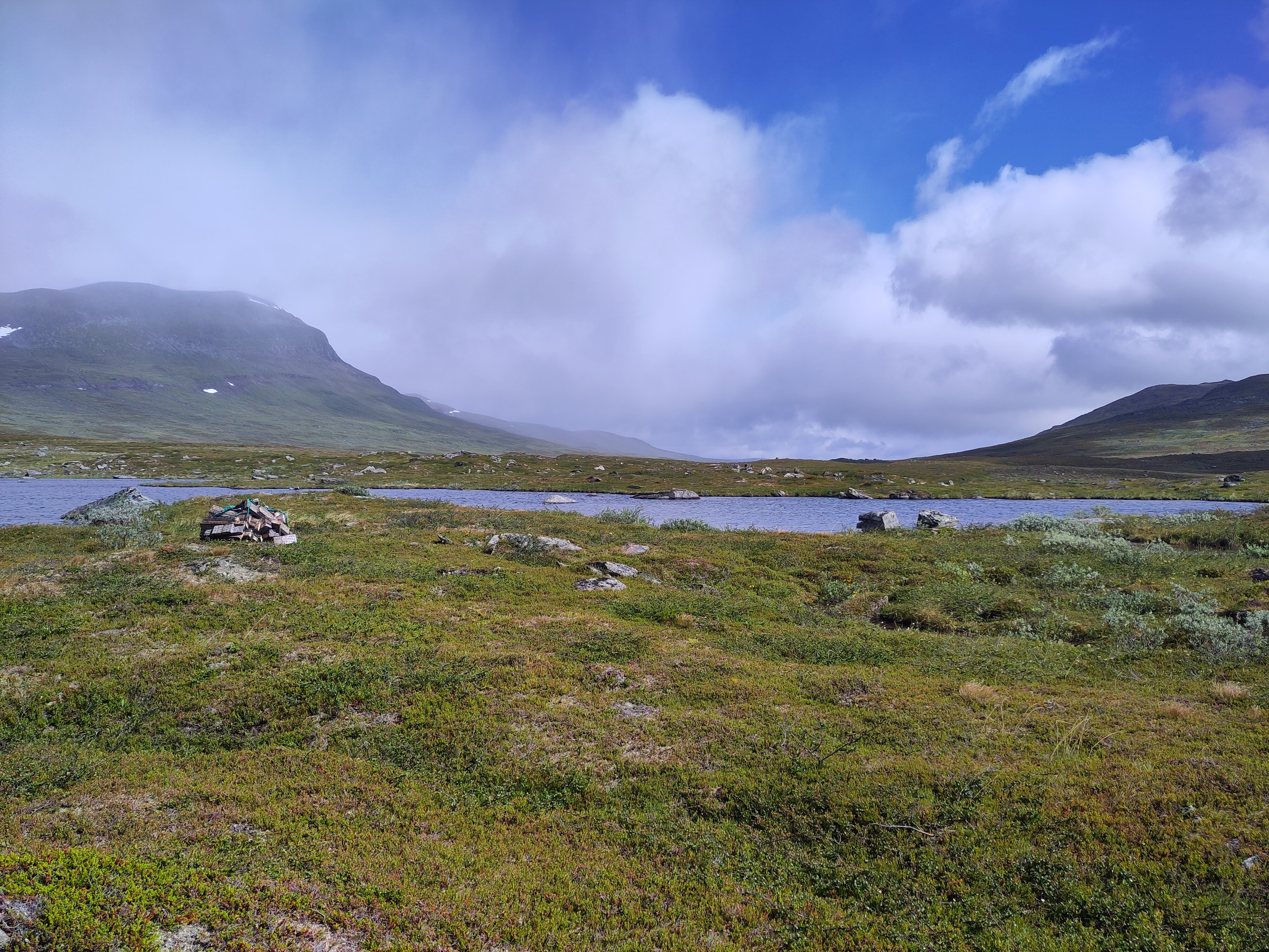 A wide shallow valley with some small lakes.